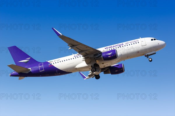 A Wataniya Airways Airbus A320 with registration mark 9K-EAH takes off from Malaga Airport