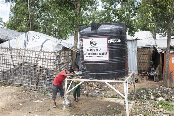 Children fetch water from a tank