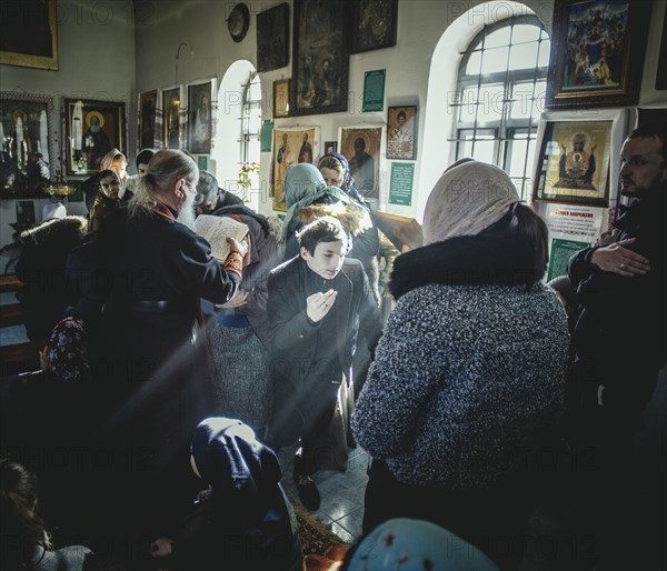 Father Sergei during an exorcism in his church in Ochamchira