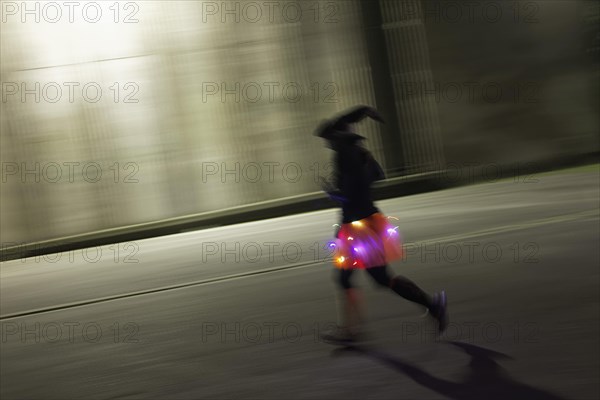 Costumed runner with witch hat