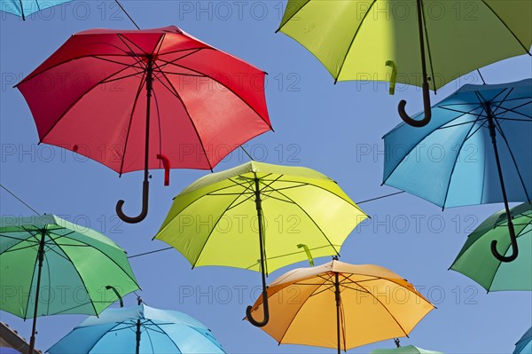 Colourful umbrellas suspended over a street