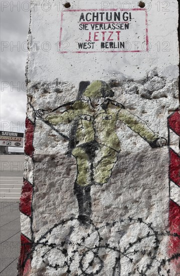 GDR border guard jumps over barbed wire to the West