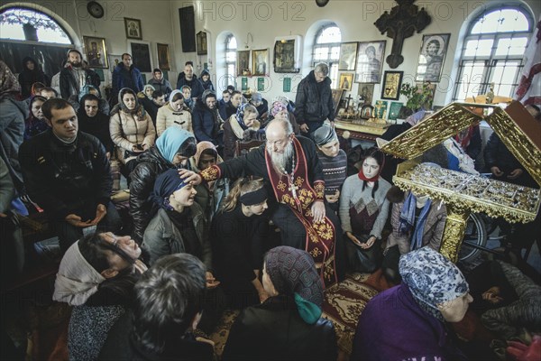 Father Sergei during an exorcism in his church in Ochamchira