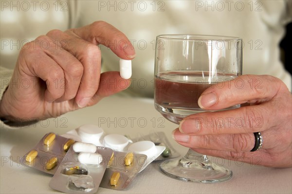 Woman holding medication pill