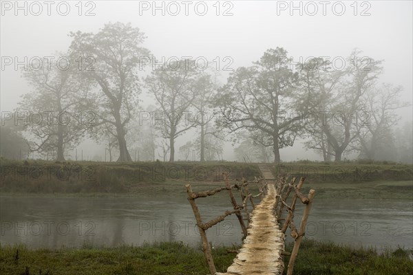 Bridge in the morning mist over the Rapti River