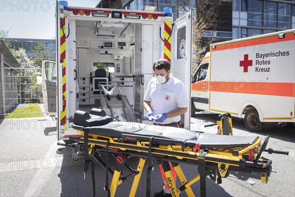 Paramedic cleans stretcher in front of Agatharied hospital