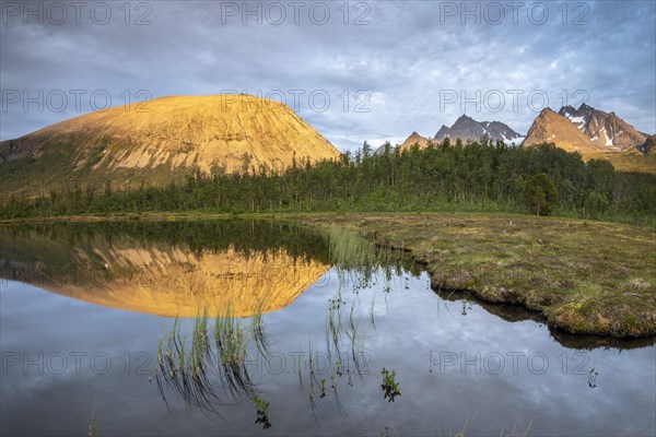 Mountains of the Lyngen Alps are reflected in the lake