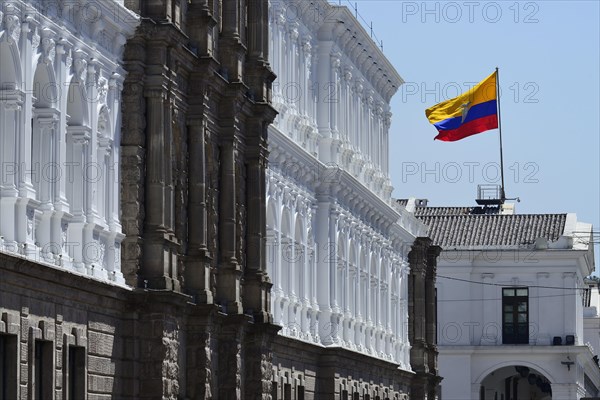 Waving national flag over the seat of government Palacio de Carondelet