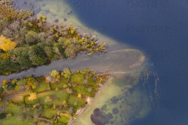 River delta of the Wangauer Ache into the Mondsee with autumnally discoloured mixed forest