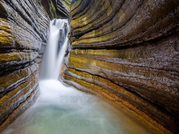 The Taugl or Tauglbach flows through the red gorge