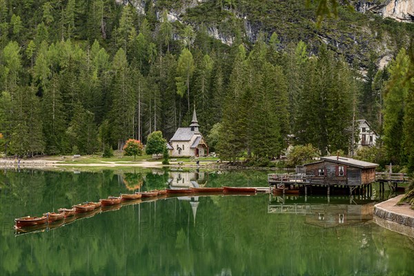 Chapel and boathouse with rowing boats at the Lake Prags Lake