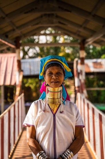 Woman with extended neck by traditional necklace