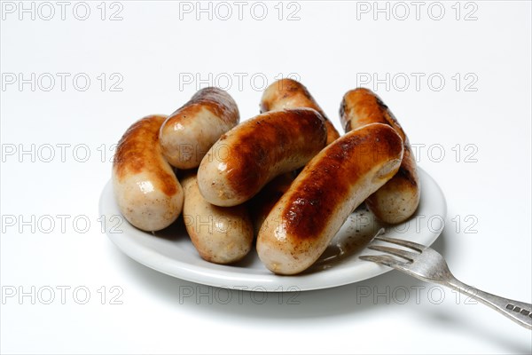 Chipolata sausages on plate