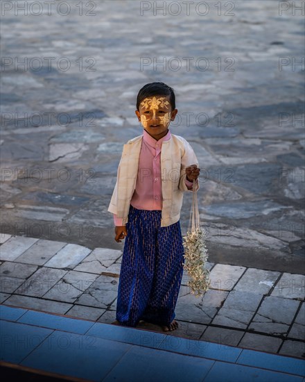 Small boy with yellow face painting