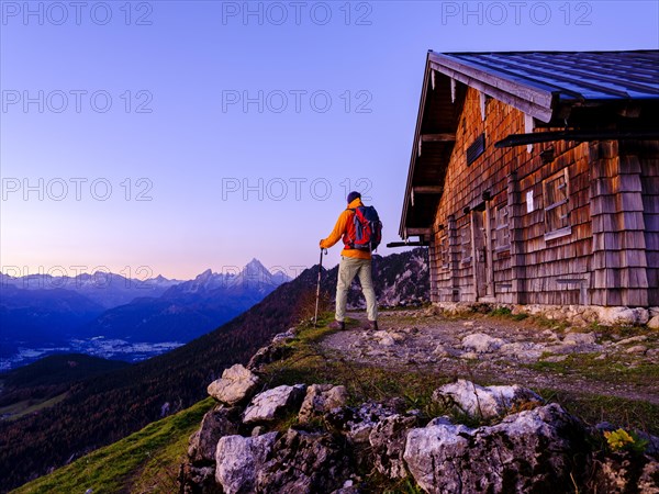 Mountaineer at the Scheibenkaser Almhuette in the morning light