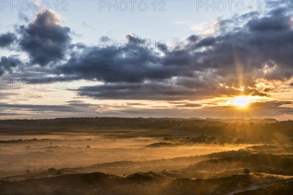 Sunrise over dune landscape with ground fog