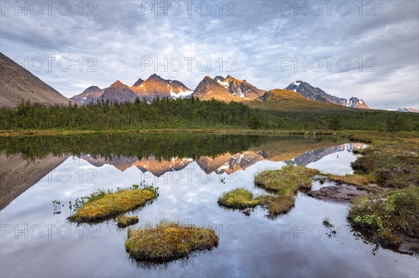 Mountains of the Lyngen Alps are reflected in the lake