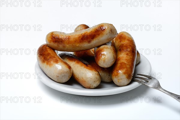 Chipolata sausages on plate
