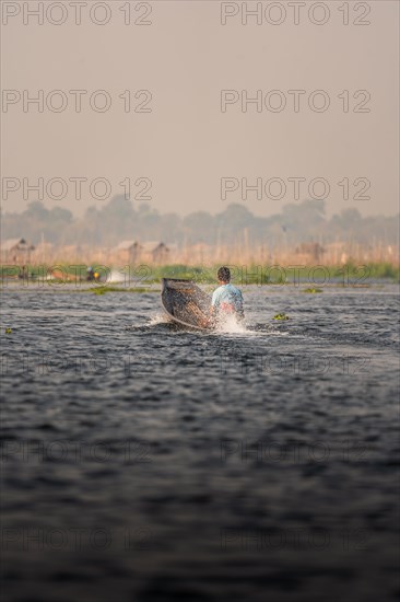 Fisherman takes his boat out on Lake Inle