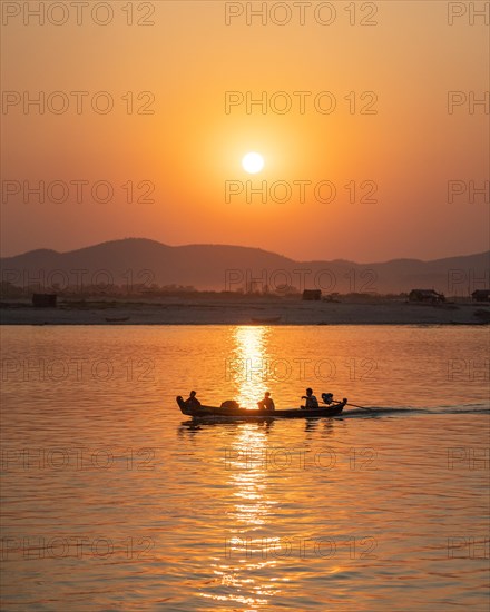 Boat with people sailing on Irrawaddy River