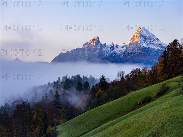 Watzmann with snow and on the left Schoenfeldspitze above Hochnebel