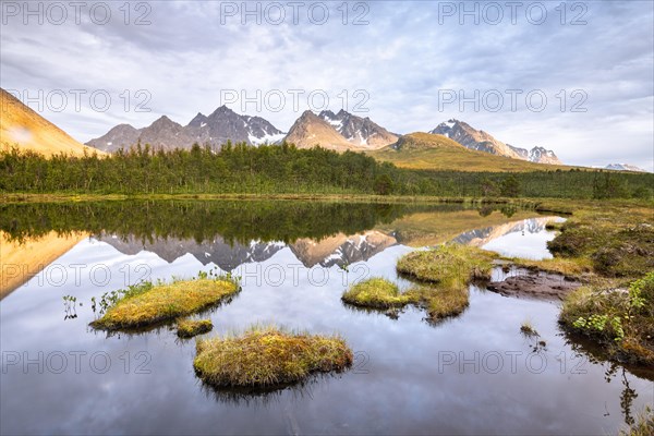 Mountains of the Lyngen Alps are reflected in the lake