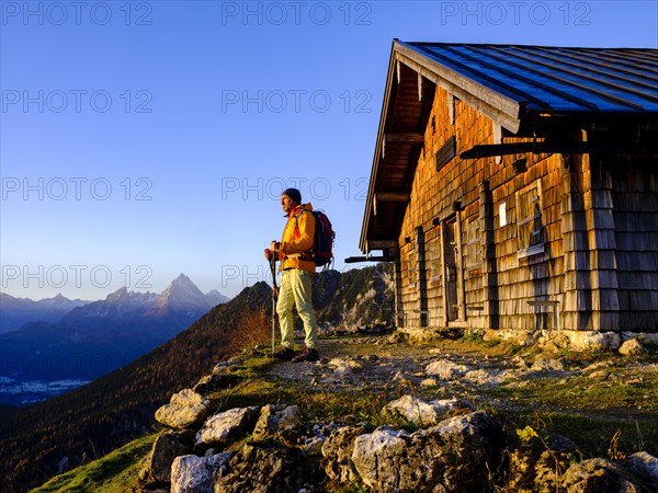 Mountaineer at the Scheibenkaser Almhuette in the morning light