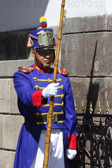 Guard in colourful uniform in front of the seat of government Palacio de Carondelet