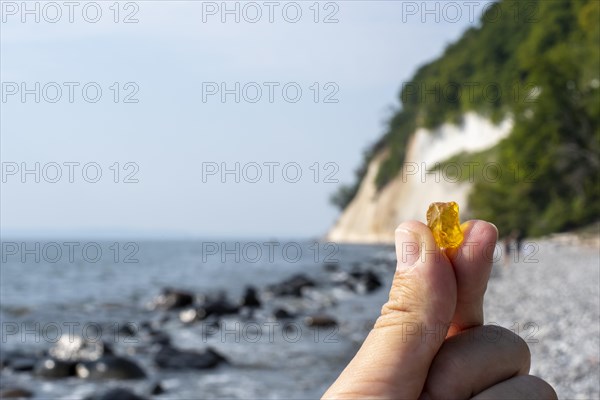 Male hand holding an amber