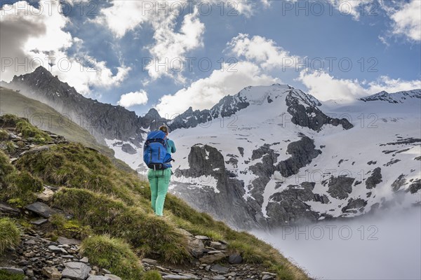 Hiking in front of snow-covered mountain peaks