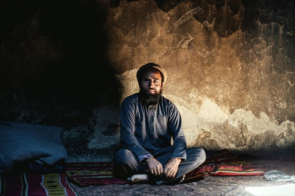 Man sitting on a carpet