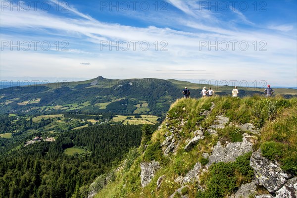 Walkers in the Sancy massif at back