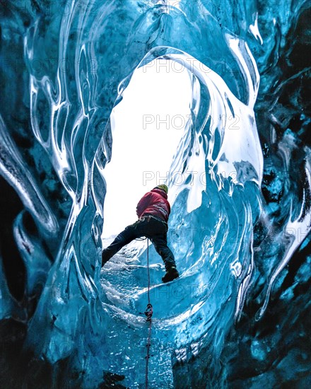 Climber in an ice cave
