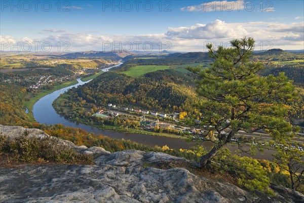 View from the autumnal Lilienstein with Wetterkiefer on the Elbe river near Koenigstein to Bad Schandau and over the German-Czech border with Mount Ruzova