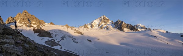 Hiker photographs mountain panorama