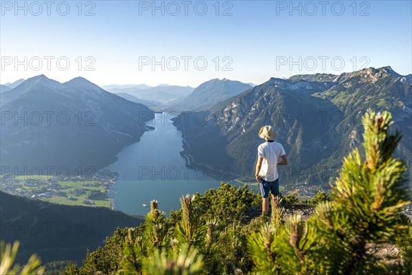 Young man looking over mountain landscape