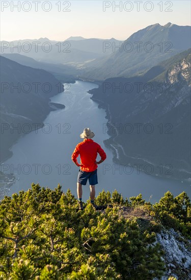 Young man looking over mountain landscape