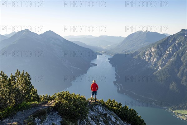 Young man looking over mountain landscape