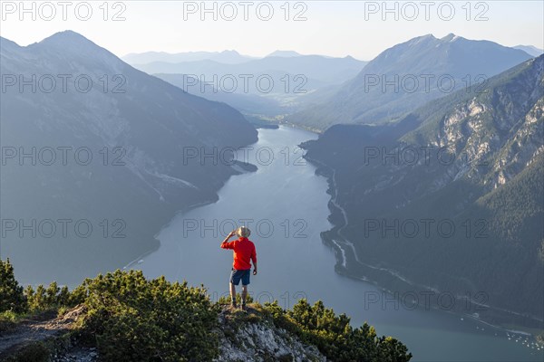 Young man looking over mountain landscape