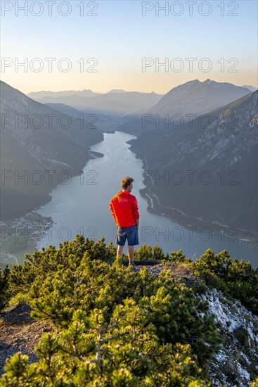 Young man looking over mountain landscape