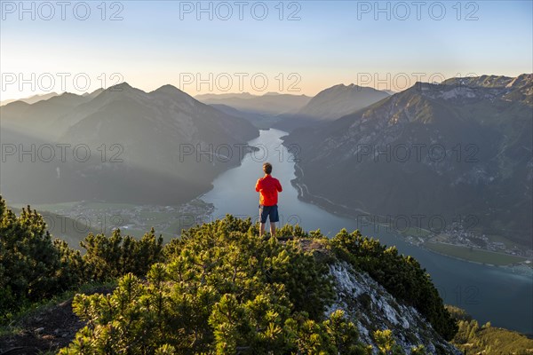 Young man looking over mountain landscape