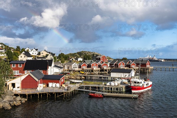 Rainbow over Rorbuer cabins in Reine