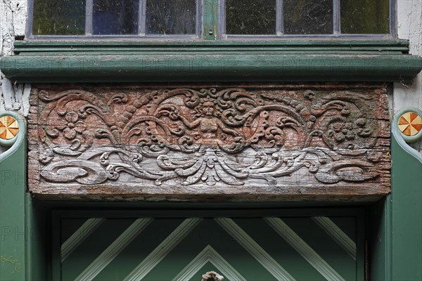 Wood carving above entrance door