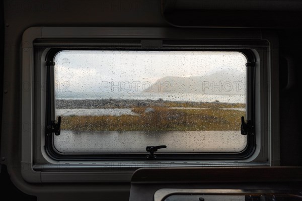View from rainy campervan kitchen window on Flakstad beach