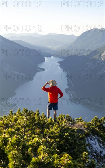 Young man looking over mountain landscape