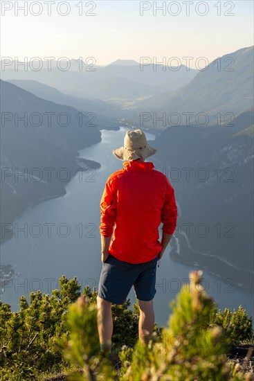 Young man looking over mountain landscape