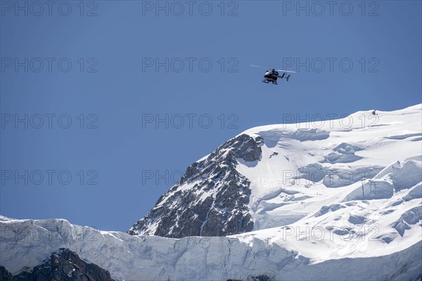 Helicopter flies over glaciers
