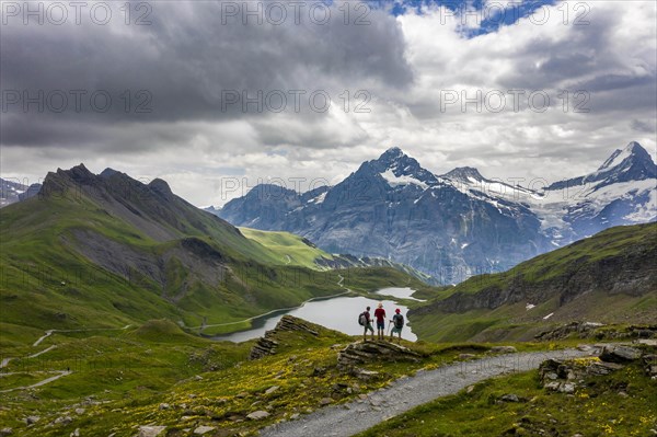 Hikers stand in front of Bachalpsee