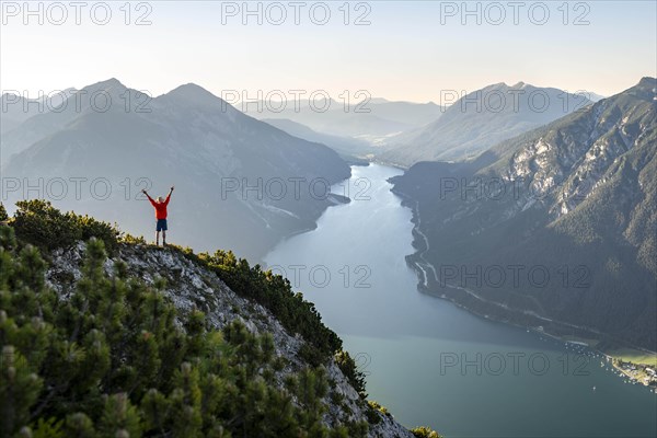 Young man stretches his arms into the air