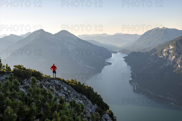 Young man looking over mountain landscape